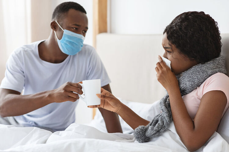 couple in bed with a cold