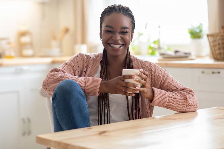 Smiling woman, holding coffee